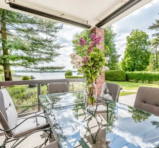Überdachter Freisitz mit Blick auf Garten und See